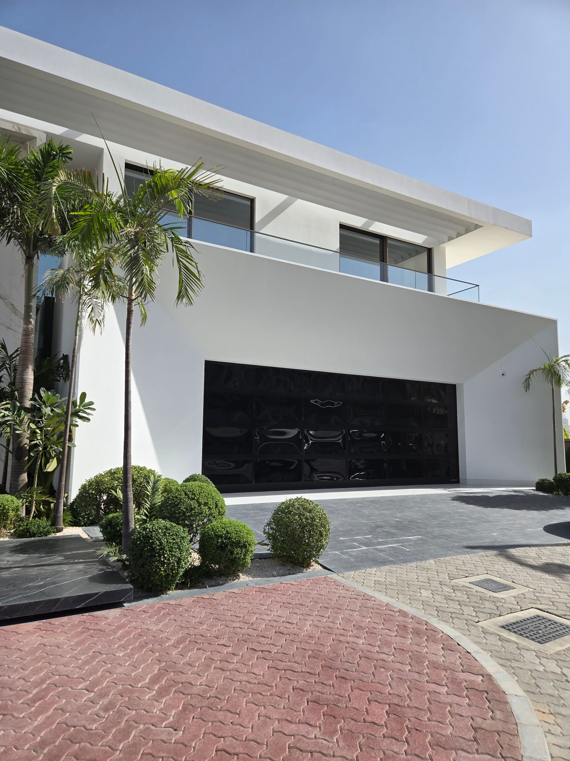 Modern white villa on Palm Jumeirah with restored dark aluminium facade