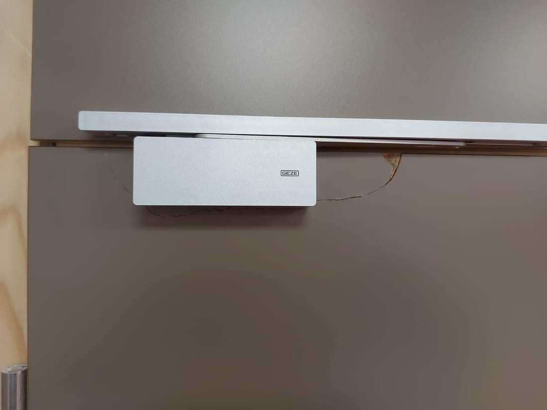 Wall above a door closer Before
